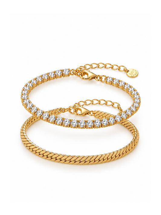 Two gold bracelets stacked on a white background. The top bracelet is a thin chain with clear stones, and the bottom bracelet is a thicker braided chain.