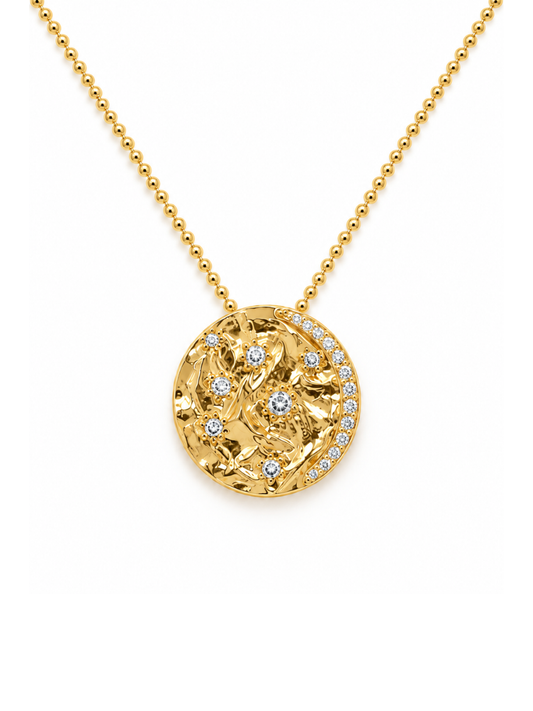 A gold ball-chain necklace with a round pendant featuring a textured floral pattern accented with small clear stones, shown on a plain white background.